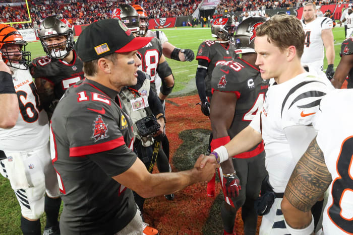 Dec 18, 2022; Tampa, Florida, USA; Tampa Bay Buccaneers quarterback Tom Brady (12) greets Cincinnati Bengals quarterback Joe Burrow (9) after a game at Raymond James Stadium. Mandatory Credit: Nathan Ray Seebeck-USA TODAY Sports